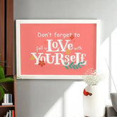 Love Yourself First Frame - Self-Love Gift displayed on grey wall, perfect for home & garden decor or personalized gift ideas.